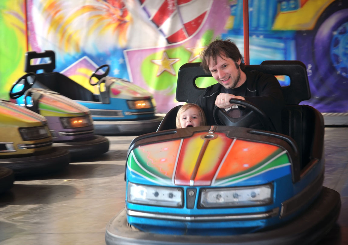father and son riding bumper cars