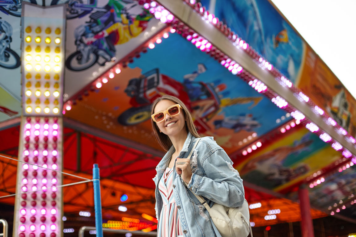 outdoor-shot-of-beautiful-young-female-in-sunglasses girl at homecoming carnival