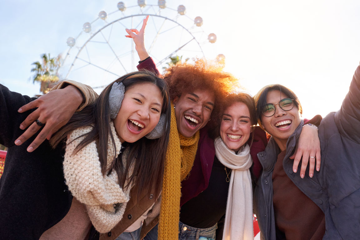 happy-multiethnic-group-of-friends-taking-a-photo group of people attending carnival corporate event