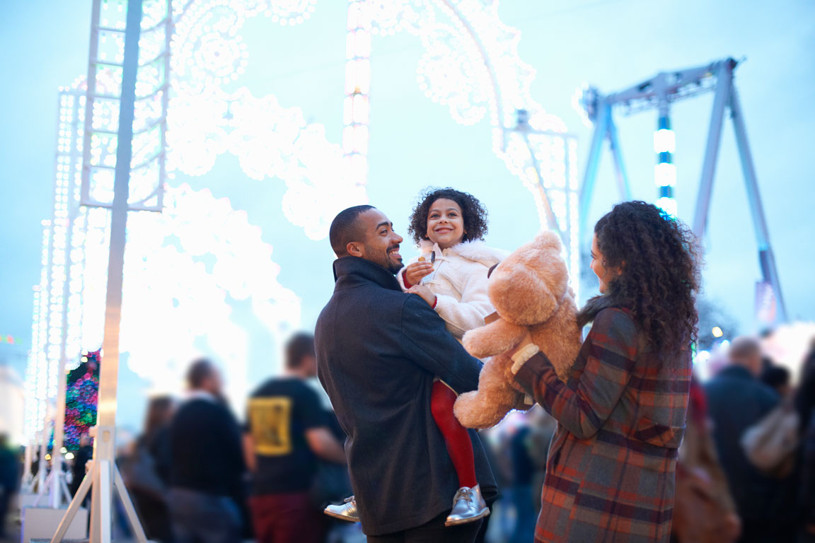 mother-and-father-in-amusement-park family at corporate carnival event